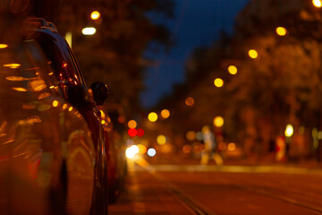 A beautifully blurred night street scene captures the essence of urban nightlife, showcasing...