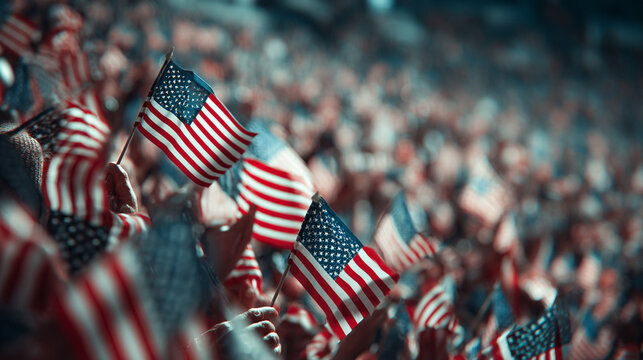 Crowd at a stadium holding tiny American flags during the national anthem