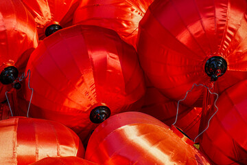 Close-up view of vibrant red silk lanterns traditionally used for Asian festivals and cultural decor