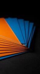 Stack of orange and blue promotional materials, perfect for print design