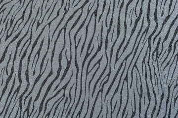 Texture of colored paper. Decorative sheet of cardboard with zebra pattern. Gray shiny background