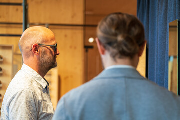 Happy man with bald head and sun glasses at shop 