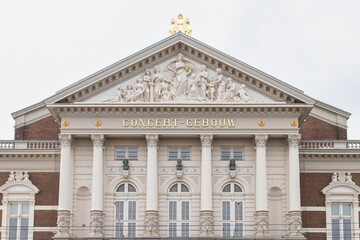Royal concert hall with the tympanum on the facade with religious reliefs in Amsterdam.
