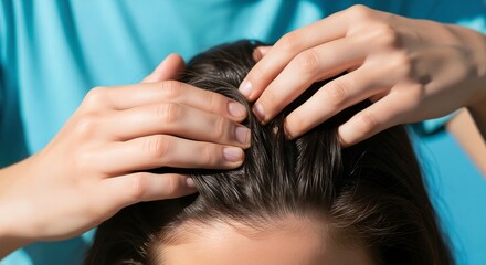 Fototapeta premium Therapist doing a scalp massage on a woman with wet hair. Hair care and trichology treatment for hair growth. Closeup of a relaxing spa procedure on blue background