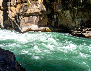 Turquoise river rushes through a rocky canyon. Perfect for adventure, nature or outdoors themes.  Evokes power, energy, and the untamed wilderness.