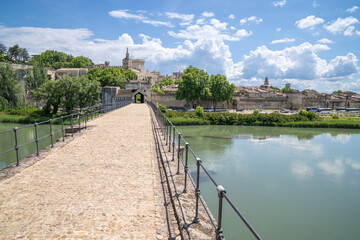 A view of the city of Avignon from the bridge over the river Rhone. Ble sky with white fluffy...