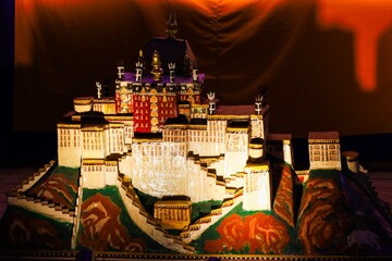 Illuminated model of Potala Palace displayed during a traditional Tibetan religious festival at Kirti Monastery in Ngawa, Amdo, showcasing sacred Himalayan architecture.