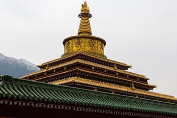 Golden 14-meter Great Stupa of Enlightenment at Labrang Monastery, a major Tibetan Buddhist site in Amdo, showcasing intricate architecture and spiritual heritage.