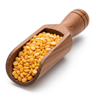 wooden scoop filled with pigeon peas on white background