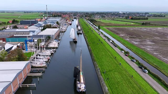 Aerial video from the yearly sailing event 'Stront race' with ancient boats in Workum Friesland the Netherlands