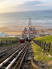 Saltburn cliff lift descending towards the beach and pier in North York Moors National Park at sunset