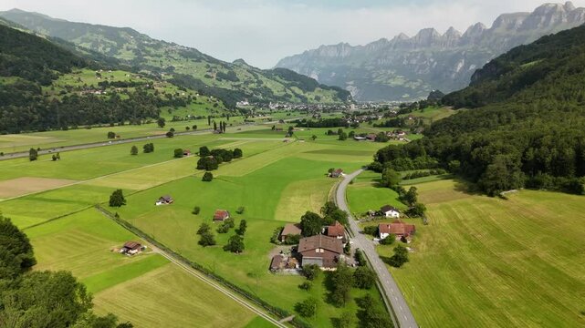 Aerial View of Swiss Farmland and Mountain Landscape Near Flums, Berschis and Walenstadt, Switzerland &ndash; Drone Footage