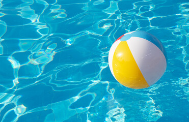 Colorful inflatable ball floating in swimming pool