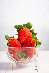 Jar with strawberries, a beautiful glass jar full of delicious strawberries on rustic wood, selective focus.