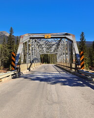 Metal, 9 panel, fixed bridge from 1950 on the Windermere Highway spanning the emerald-green Bow River next to Castle Junction. Banff NP-AB-Canada-374