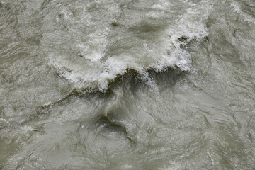 Dirty streams are flowing down the mountain slopes of the mountains