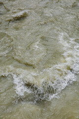 Dirty streams are flowing down the mountain slopes of the mountains