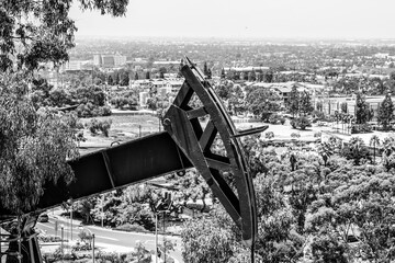 black and white oil pumpjack over the city landscape