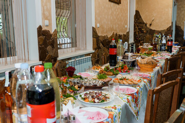 Festive Eastern European Feast: Abundant Table Setting With Food, Drinks, Interior Decor, Stone Wall, Traditional Hospitality, Warm Light.