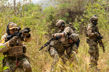 Fototapeta premium Soldier Carrying Injured Comrade During Tactical Combat Mission – Military Rescue Operation in Jungle, Armed Forces in Full Gear Providing Assistance Under Fire, Real Battlefield Scene
