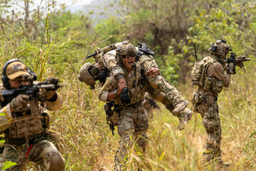 Soldier Carrying Injured Comrade During Tactical Combat Mission – Military Rescue Operation in...