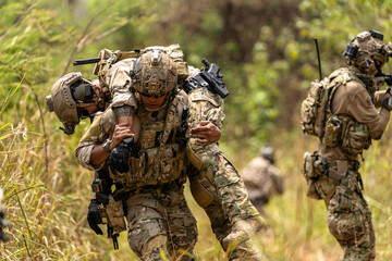 Soldier Carrying Injured Comrade During Tactical Combat Mission – Military Rescue Operation in...