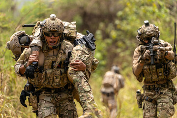 Soldier Carrying Injured Comrade During Tactical Combat Mission – Military Rescue Operation in...