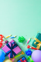 Birthday party background: Flat lay composition with colorful gift boxes, balloons, candles, and...