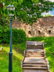 Charming staircase leading to a historic wall with embrasures, where soldiers once defended against...