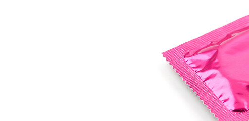 Bright hit pink condom wrapper, white background, copy space. Safe sex protection contraceptive wallpaper backdrop, STD prevention, Valentines Day