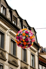 Konstanz, Germany- May 28, 2025: Konstanz old town (altstadt) flower balls colorful decorations hanging above street slley