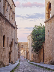 View of the street of the Knights of Rhodes island under a pastel evening sky with soft clouds. Rhodes island, Greece