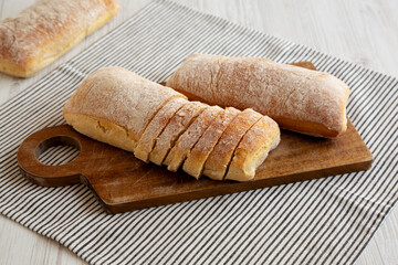 Homemade Ciabatta Bread on a wooden board, side view.