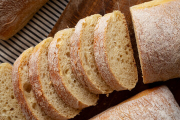 Homemade Ciabatta Bread on a wooden board, top view. Close-up.