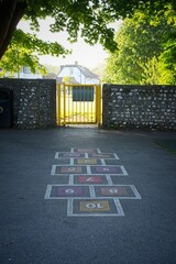 Hopscotch and gate in urban playground