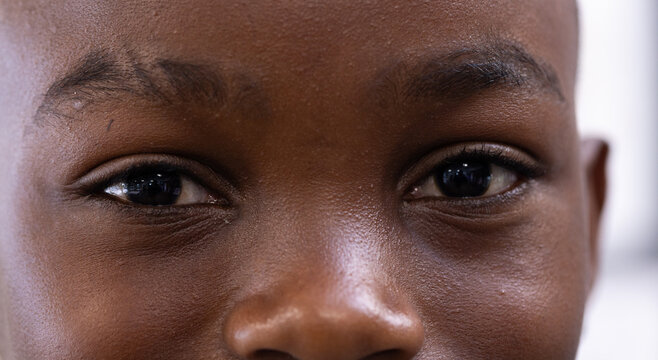 Close-up of boy's eyes showing curiosity and focus in school environment