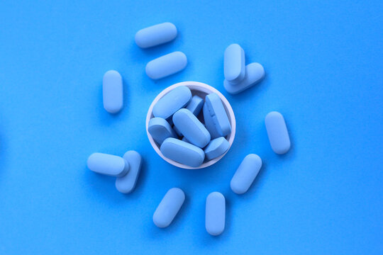 Blue PrEP pills, used for HIV prevention. - Powered by Adobe