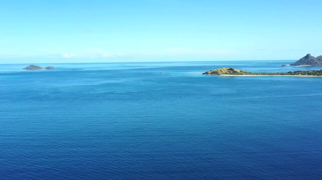 Distant majestic islands in Pacific ocean at Fiji &ndash; coral reefs and lagoons aerial 4k.
