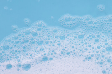 Blue water with white foam bubbles