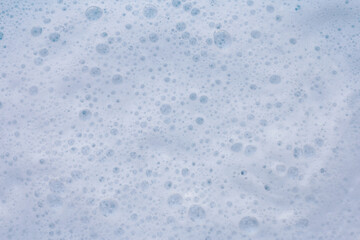 Blue water with white foam bubbles