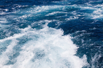 Ocean water background with foam. Ocean water splash. Not a calm