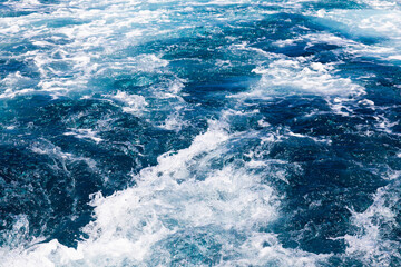 Ocean water background with foam. Ocean water splash. Not a calm