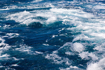Ocean water background with foam. Ocean water splash. Not a calm