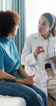 Appointment, women and doctor with tablet, hospital and explaining medical diagnosis and discussion. Help, people and healthcare worker with tech for patient records, treatment and advice in clinic
