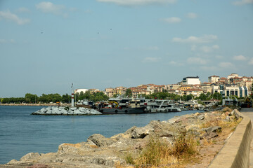 Bustling Kartal Marina in Istanbul Turkey with Colorful Fishing Boats, Luxury Yachts and Sailboats Moored in Sunny Mediterranean Harbor with Rocky Coastline
