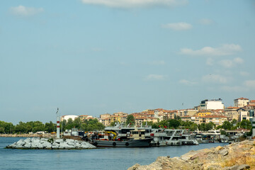 Bustling Kartal Marina in Istanbul Turkey with Colorful Fishing Boats, Luxury Yachts and Sailboats Moored in Sunny Mediterranean Harbor with Rocky Coastline