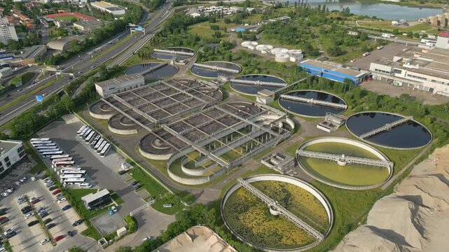 Eco-friendly aerial view of wastewater treatment plant near Lyon, France, with urban skyline &ndash; sustainable water management and environmental protection concept