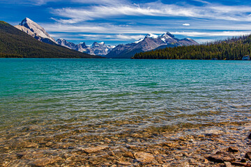 Maligne Lake in Jasper National Park surrounded with snow capped mountains