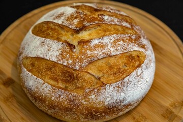 Freshly baked artisan sourdough bread on a wooden board.