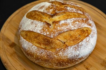 Freshly baked artisan sourdough bread on a wooden board.